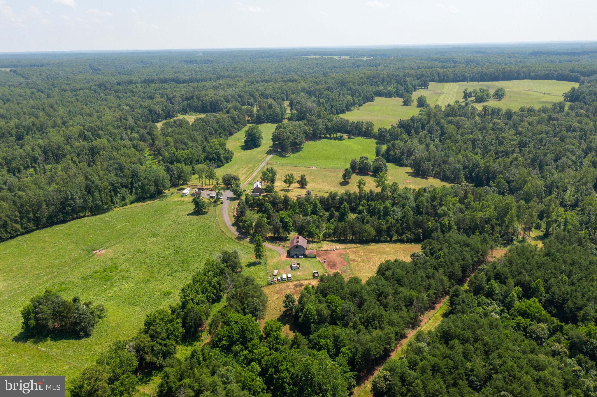 11997 Bristersburg Road Midland, VA 22728 - Photo 25 of 38 an aerial view of green landscape with trees houses and mountain view
