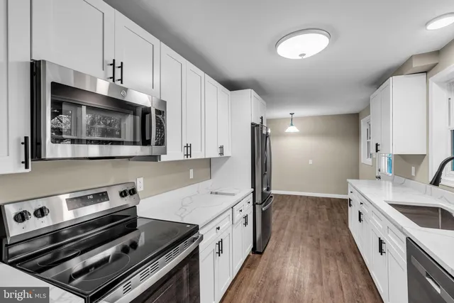 a kitchen with a stove oven and sink