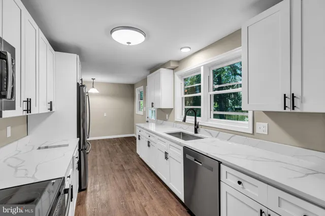 a kitchen with a sink stove and cabinets
