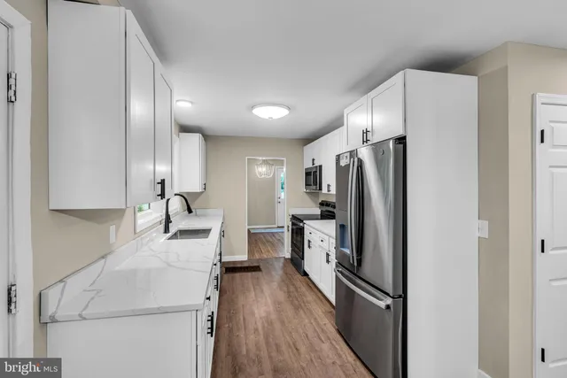 a kitchen with stainless steel appliances a refrigerator sink and stove