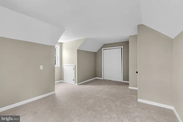 a front view of house with yard and tree in it