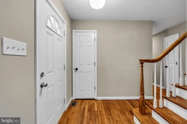 a view of front door with wooden floor