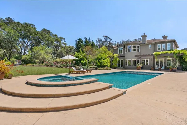 an aerial view of a house with a swimming pool