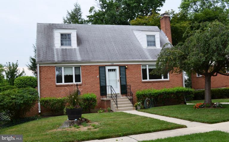 12702 Feldon Street Silver Spring, MD 20906 - Photo 3 of 11 a front view of a house with a yard and trees