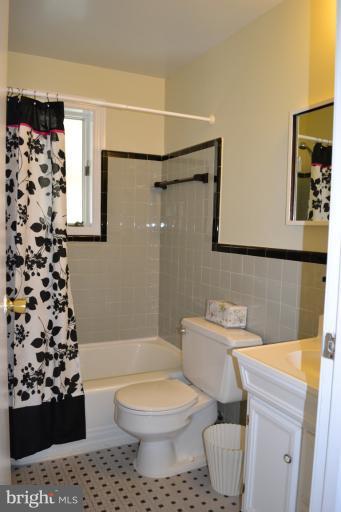 12702 Feldon Street Silver Spring, MD 20906 - Photo 6 of 11 a bathroom with a toilet a sink and a shower