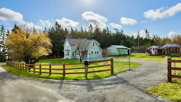 a view of a house with a big yard and potted plants