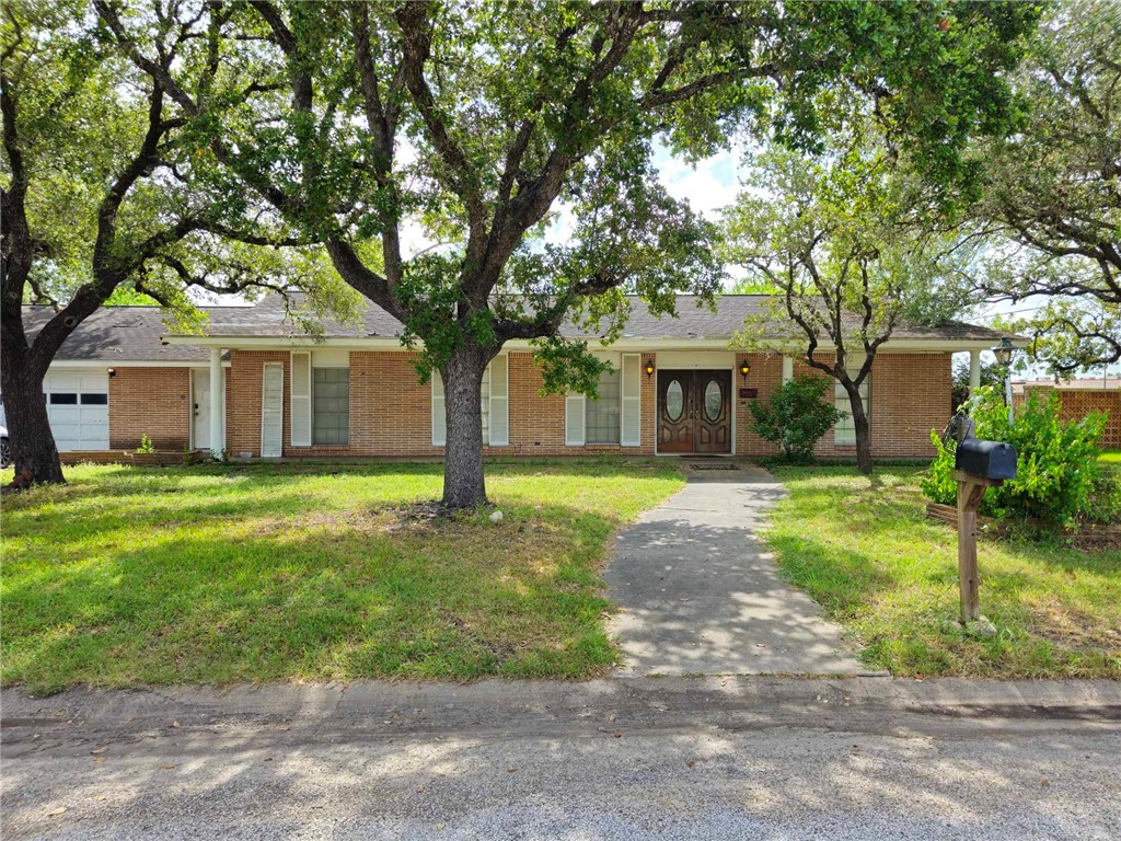 602 Kate Street Refugio, TX 78377 - Photo 1 of 1 a front view of a house with a yard and garage