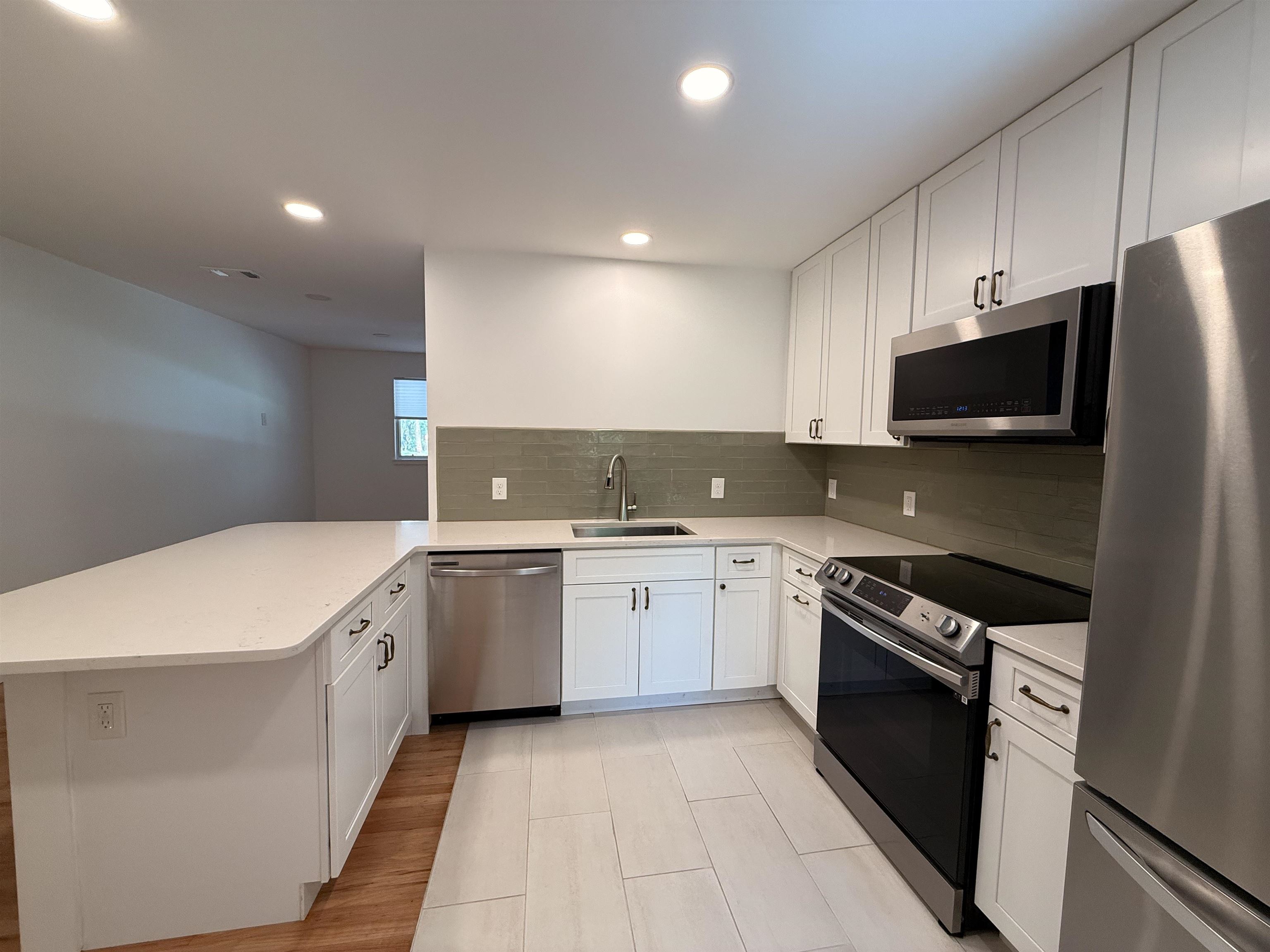 521 Christopher Street St. Augustine, FL 32084 - Photo 5 of 17 a kitchen with a sink stove and microwave