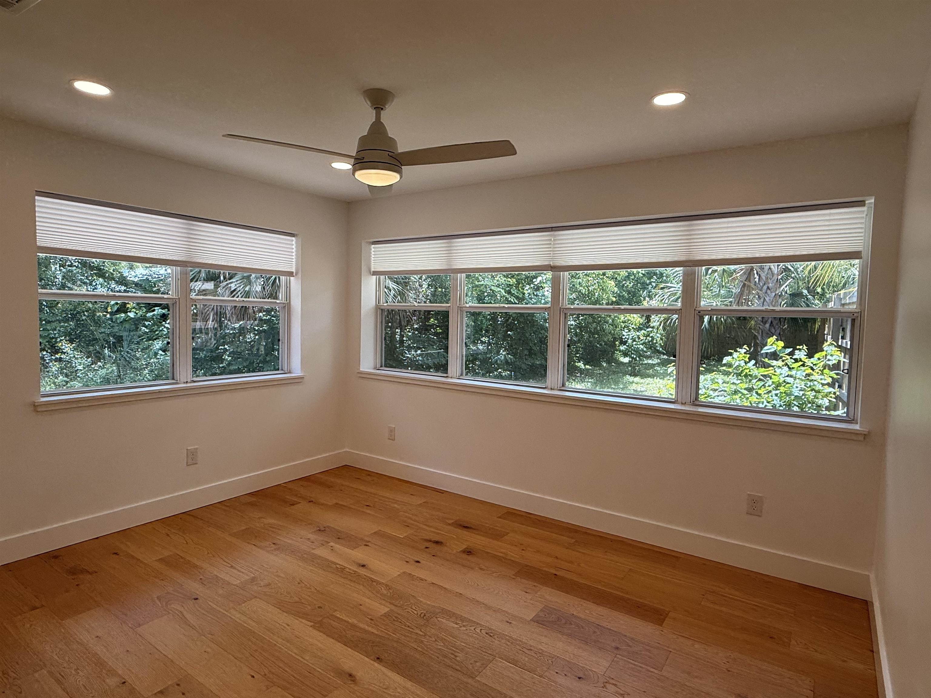 521 Christopher Street St. Augustine, FL 32084 - Photo 7 of 17 a view of empty room with wooden floor and fan