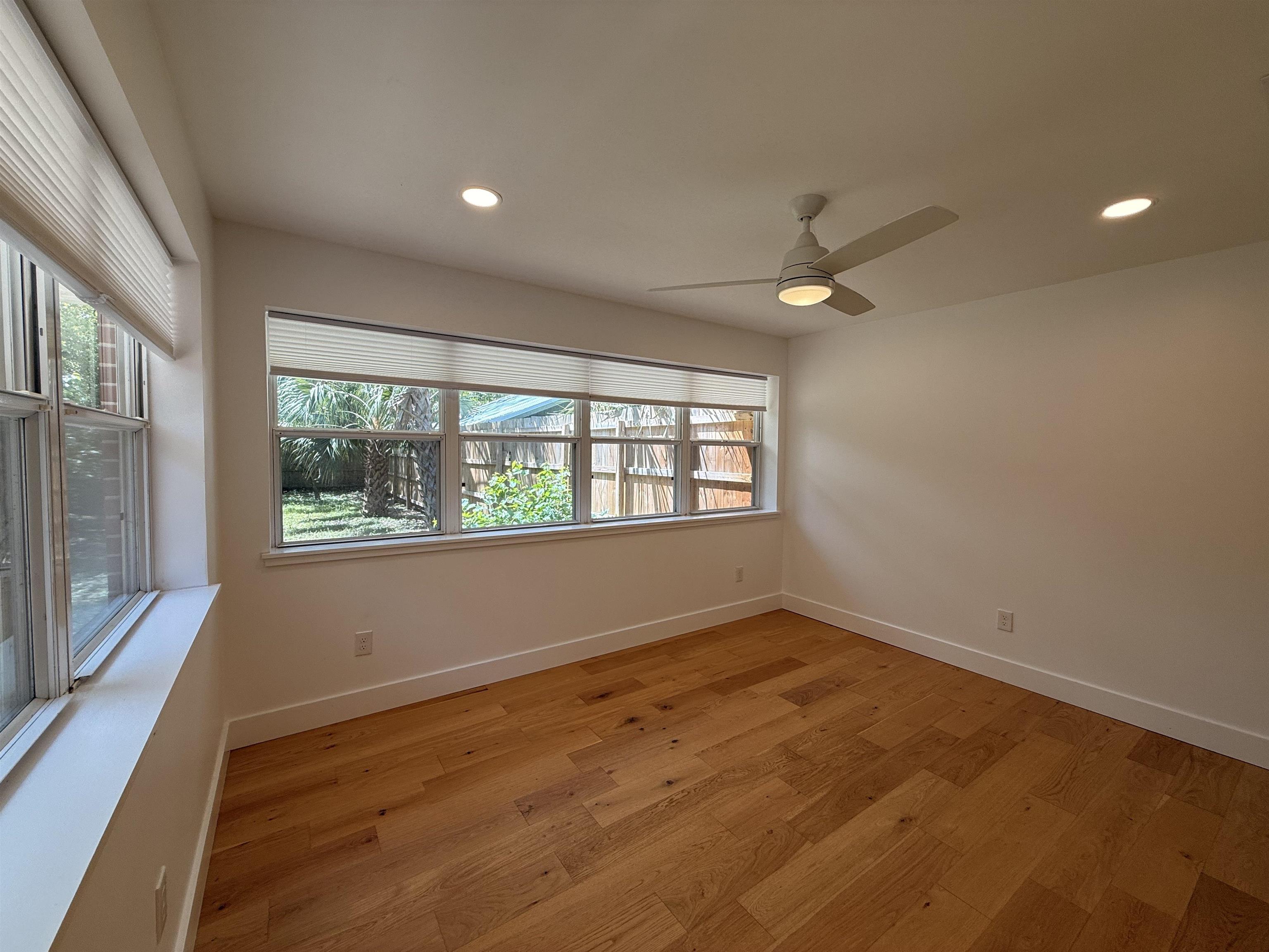 521 Christopher Street St. Augustine, FL 32084 - Photo 8 of 17 an empty room with wooden floor and windows