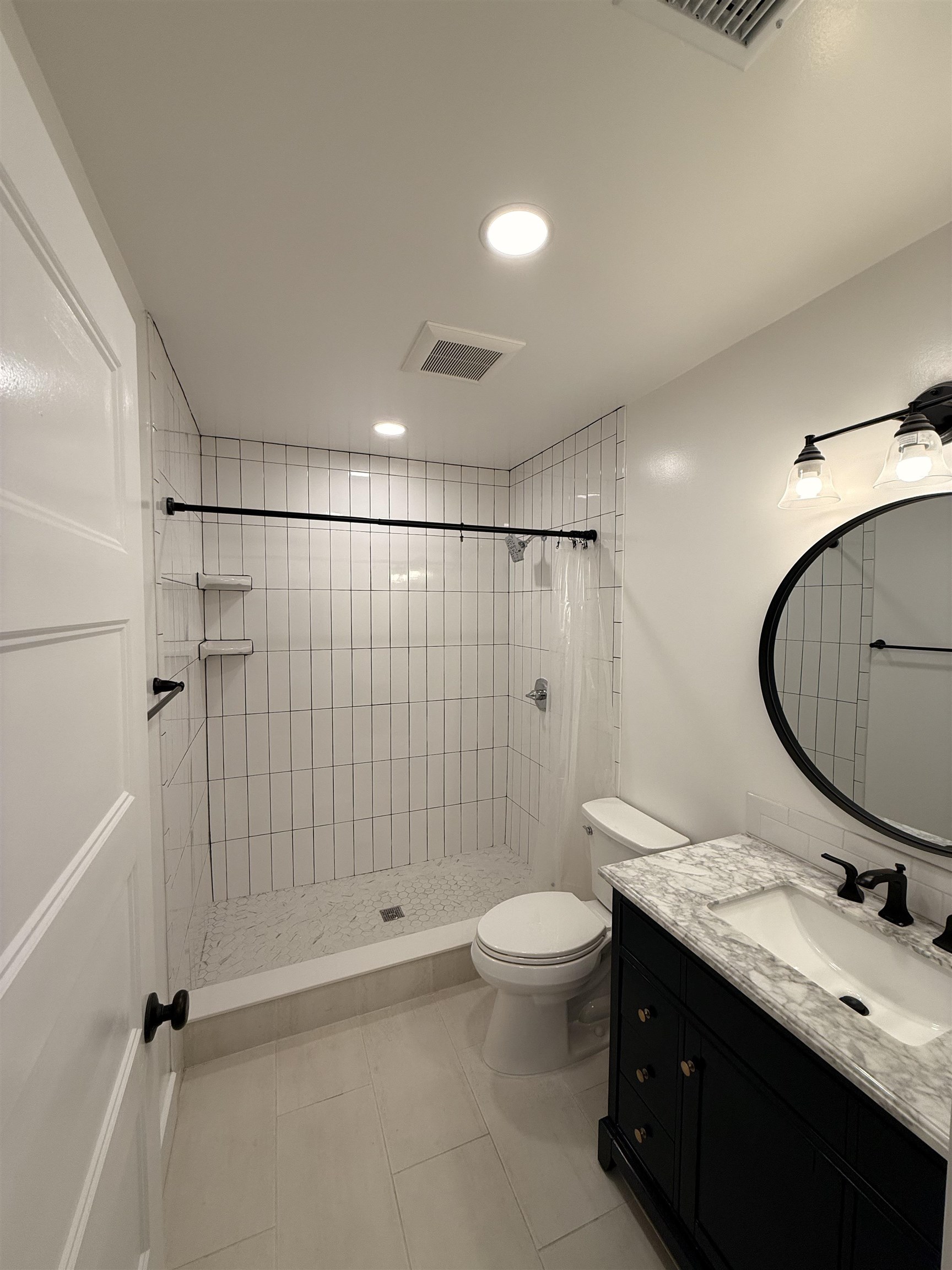 521 Christopher Street St. Augustine, FL 32084 - Photo 9 of 17 a bathroom with a double vanity sink toilet mirror and shower