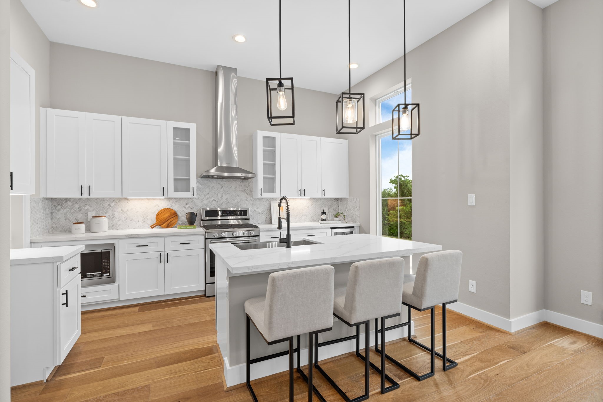 1177 West 19th Street Houston, TX 77008 - Photo 21 of 40 a kitchen with stainless steel appliances granite countertop a sink a stove a refrigerator and island with wooden floor