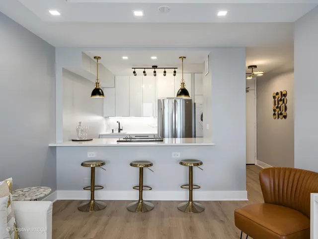 a living room with furniture and view of kitchen