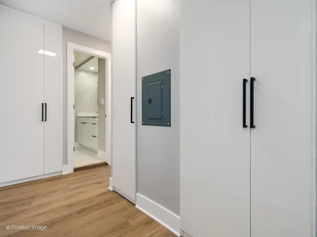 an empty room with wooden floor and mirror