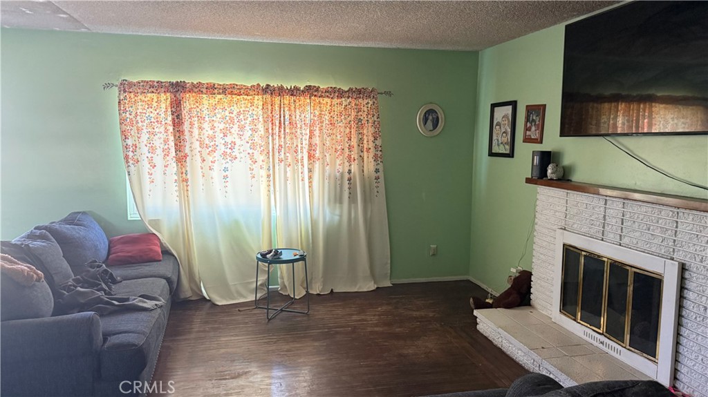 411 East Jackson Street Rialto, CA 92376 - Photo 4 of 5 a living room with furniture and a fireplace