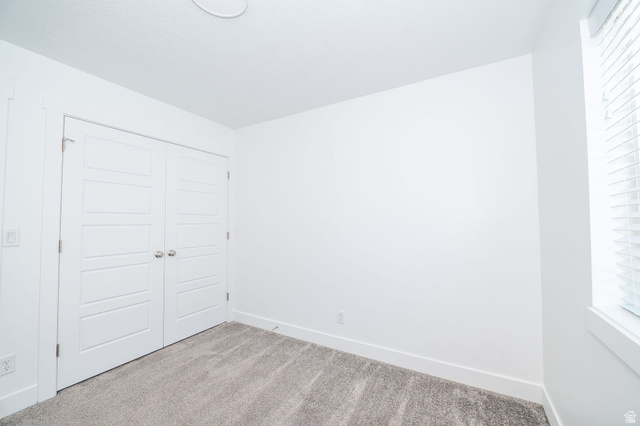 46 West 460 Smithfield, UT 84335 - Photo 15 of 31 Carpeted interior space featuring white walls and a pair of white paneled bifold doors with chrome hardware
