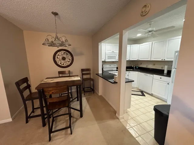 a kitchen with a table and chairs in it