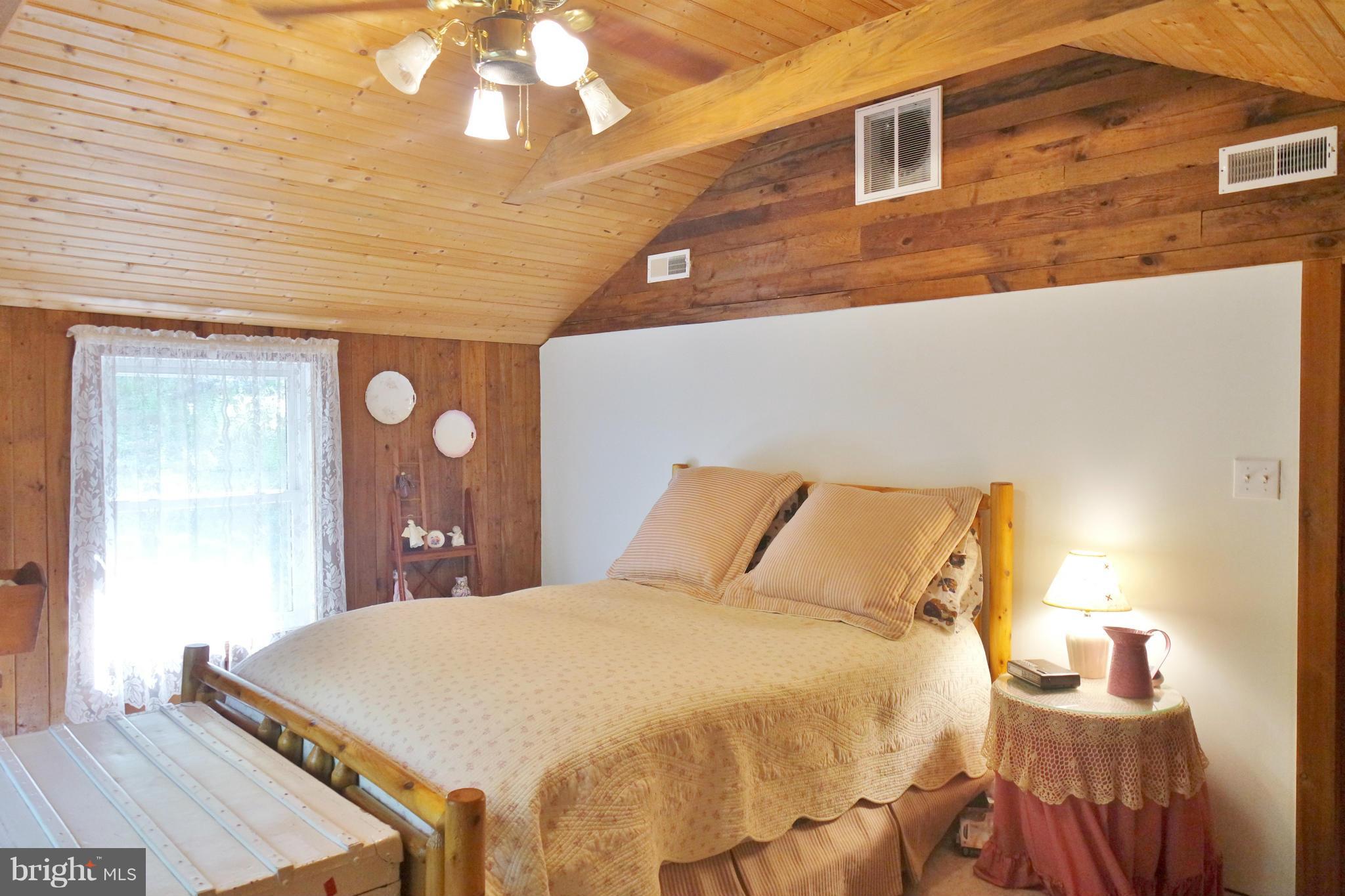 974 North Maple Road Mount Jackson, VA 22842 - Photo 18 of 30 a bed sitting in a bedroom next to a window