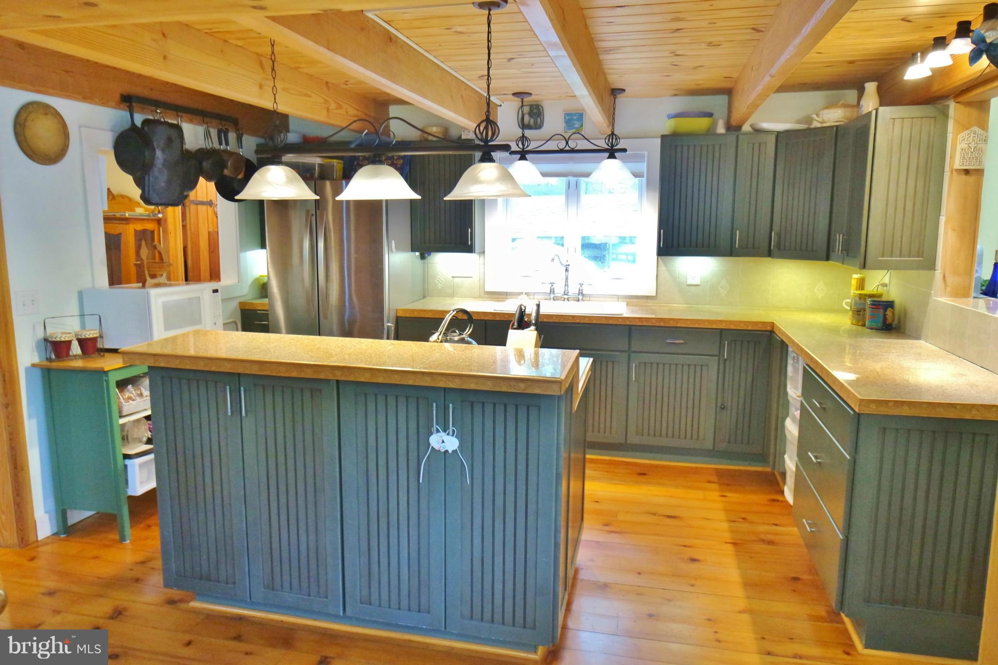 974 North Maple Road Mount Jackson, VA 22842 - Photo 3 of 30 a kitchen with a sink and wooden cabinets