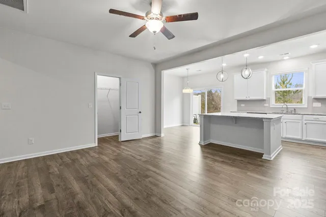a view of kitchen with granite countertop cabinets and wooden floor