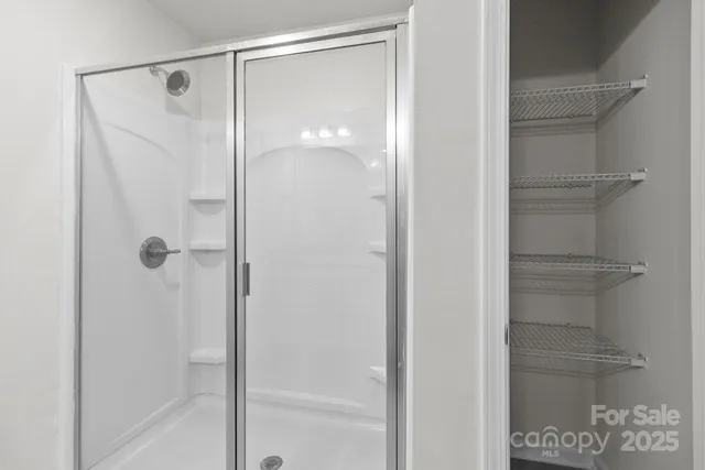 a bathroom with a glass shower door