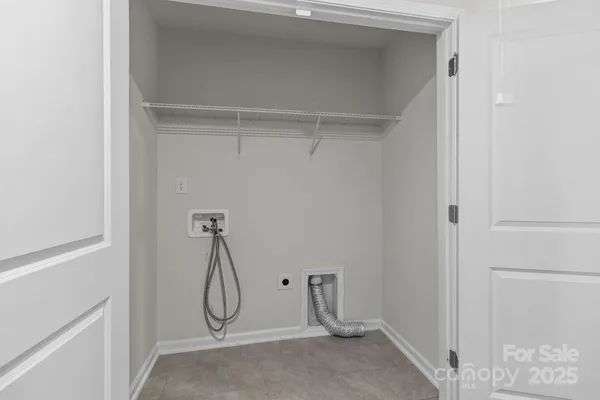 a room with white cabinets and glass door