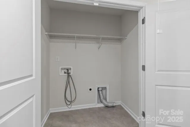 a room with white cabinets and glass door