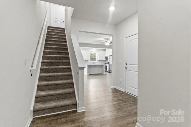 a view of entryway and hall with wooden floor
