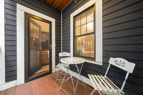 a view of a balcony with chairs