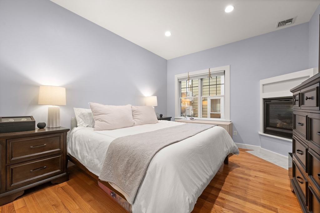 345 West Broadway, Unit 4 Boston, MA 02127 - Photo 14 of 26 a bedroom with bed and a flat tv screen on dresser