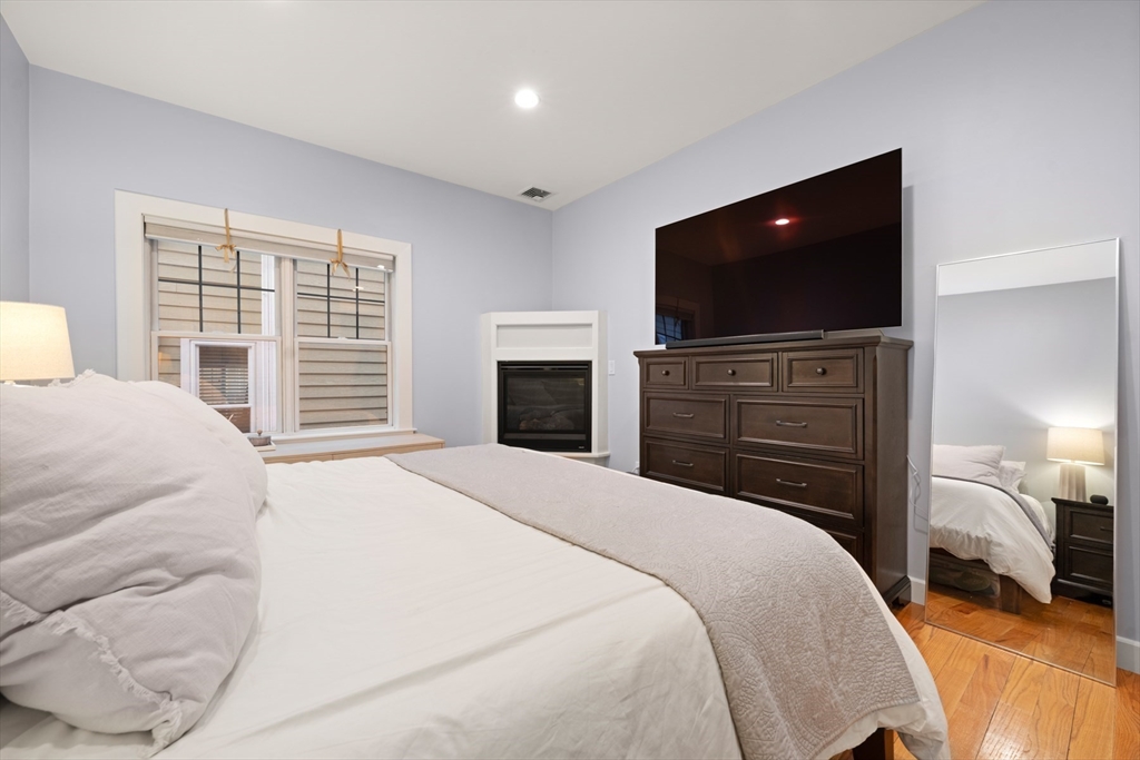 345 West Broadway, Unit 4 Boston, MA 02127 - Photo 15 of 26 a bedroom with a bed and a flat screen tv