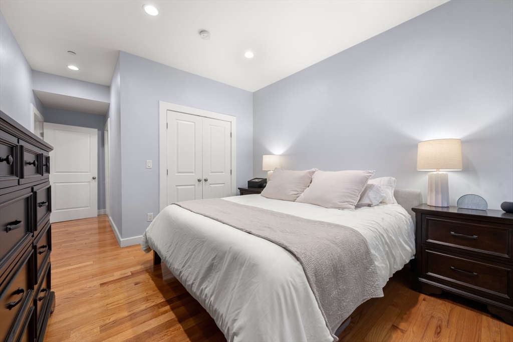 345 West Broadway, Unit 4 Boston, MA 02127 - Photo 16 of 26 a spacious bedroom with a bed and a lamp