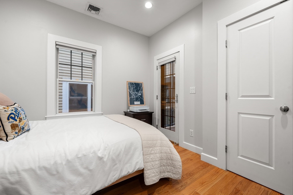 345 West Broadway, Unit 4 Boston, MA 02127 - Photo 19 of 26 a large bed sitting in a bedroom next to a window and dresser