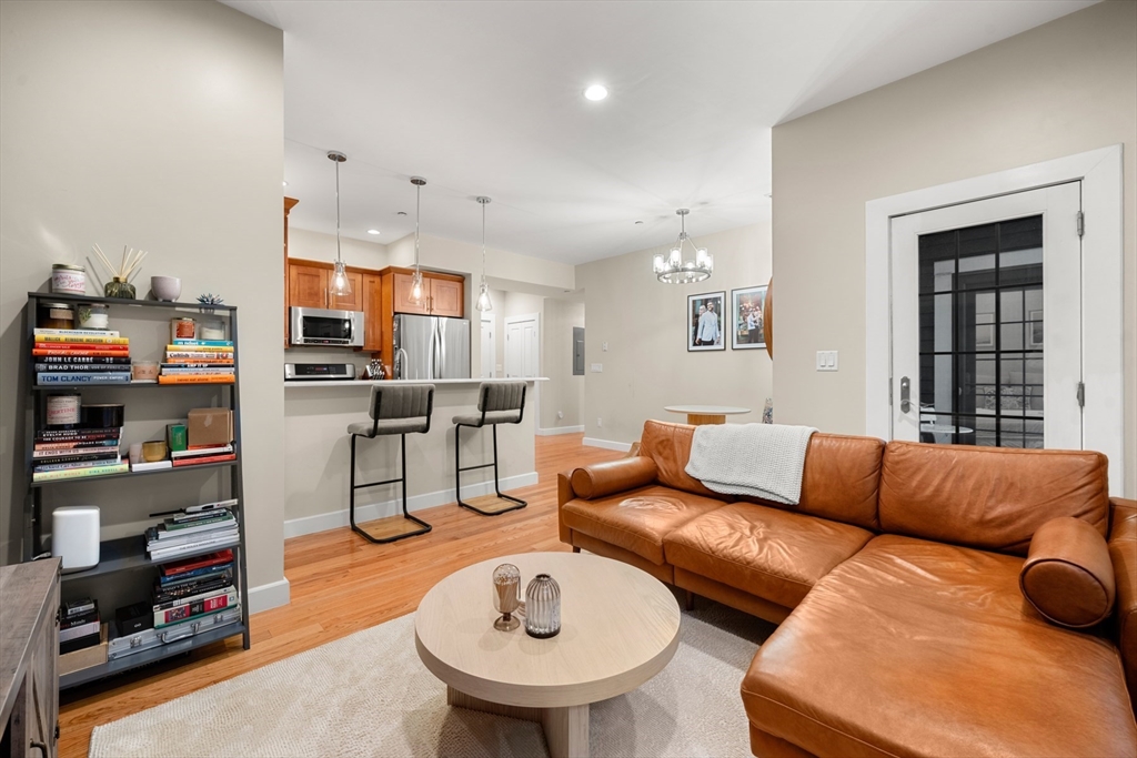 345 West Broadway, Unit 4 Boston, MA 02127 - Photo 2 of 26 a living room with furniture and a kitchen view