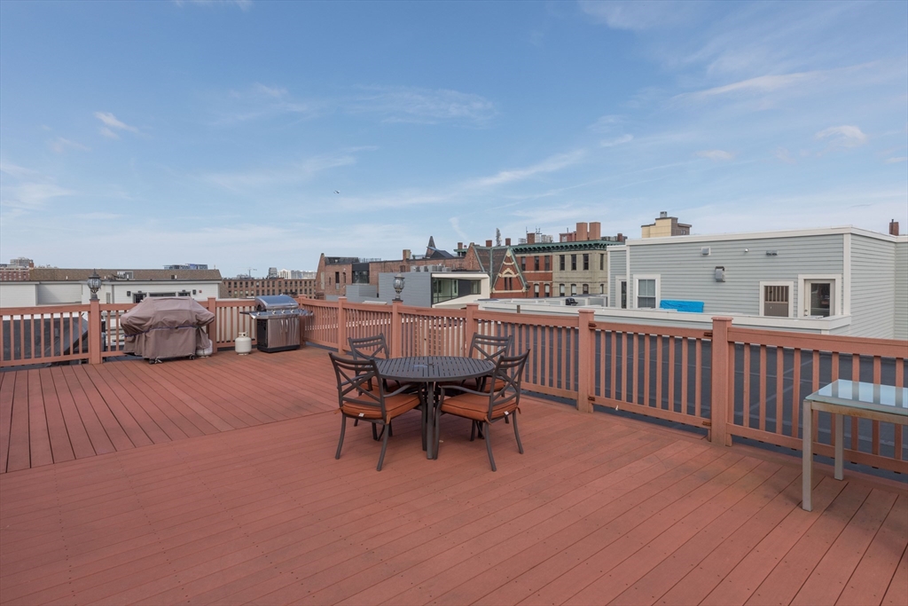 345 West Broadway, Unit 4 Boston, MA 02127 - Photo 23 of 26 a balcony with furniture and wooden floor
