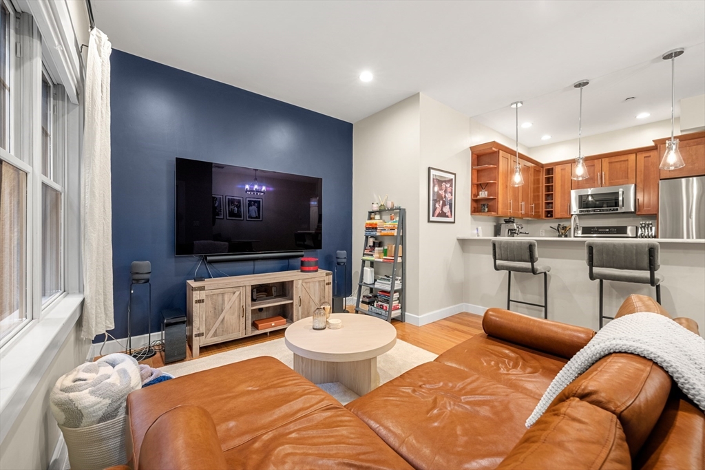 345 West Broadway, Unit 4 Boston, MA 02127 - Photo 6 of 26 a living room with furniture and a flat screen tv