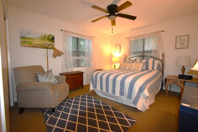 a spacious bedroom with a bed and a chandelier