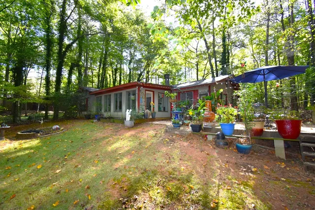 a view of a house with backyard porch and sitting area