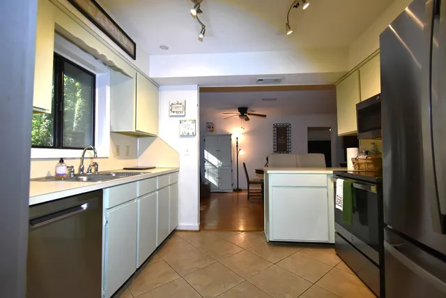 a kitchen with a sink and refrigerator