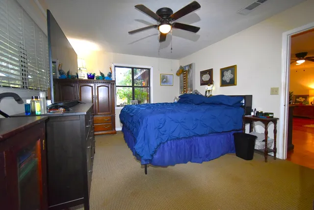 a bed room with a bed window and a chandelier