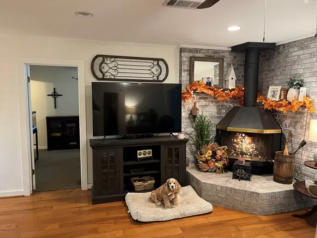 a living room with furniture and a flat screen tv