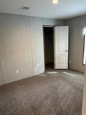 a view of an empty room and closet area
