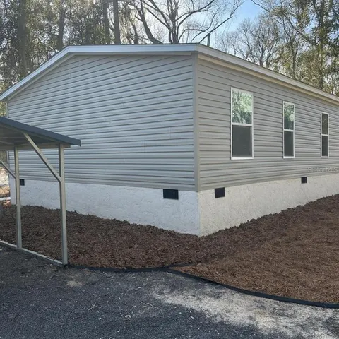 a view of a house with a backyard
