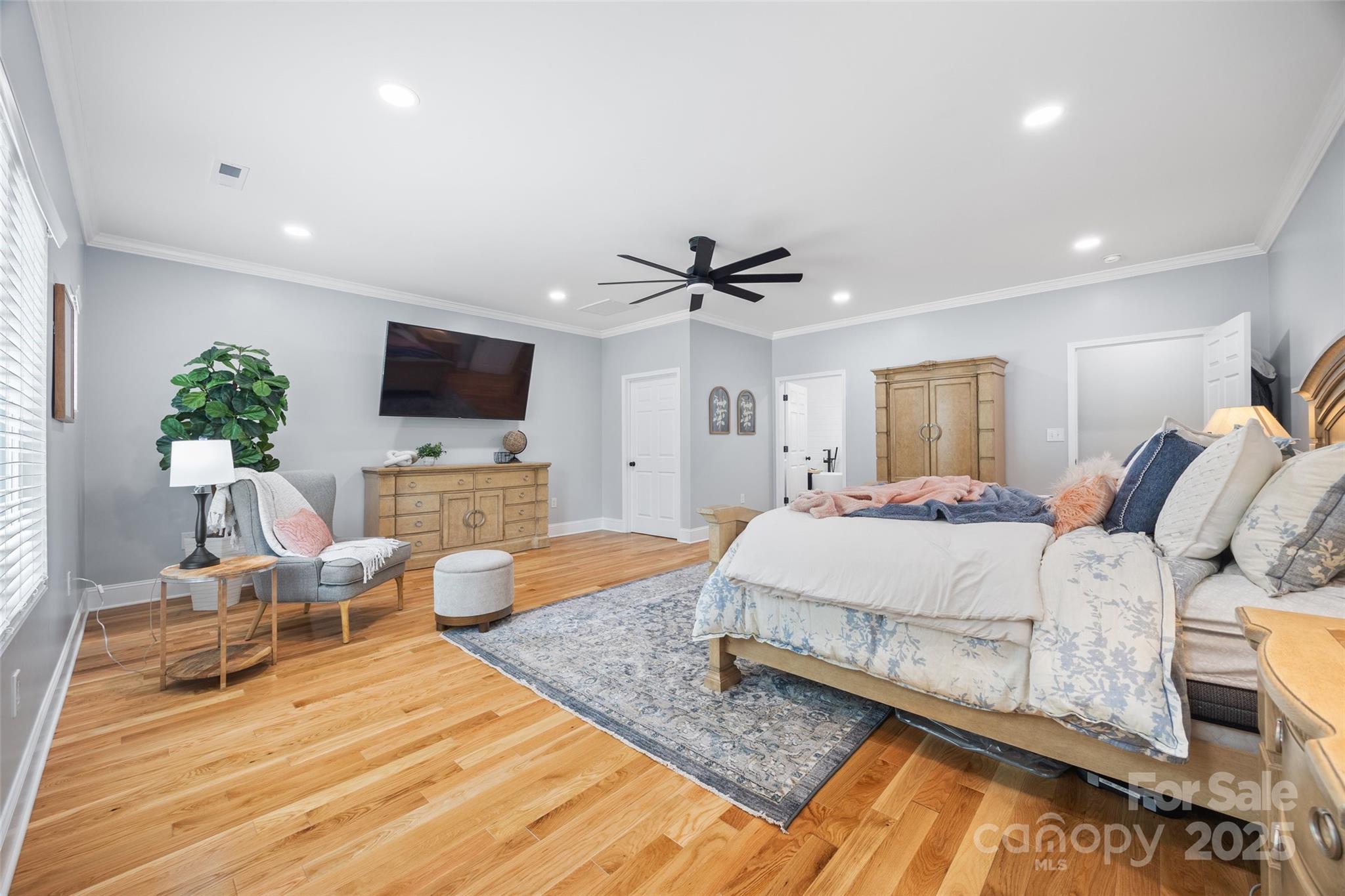 184 Quiet Cove Road Mooresville, NC 28117 - Photo 13 of 45 a spacious bedroom with a bed and a flat screen tv