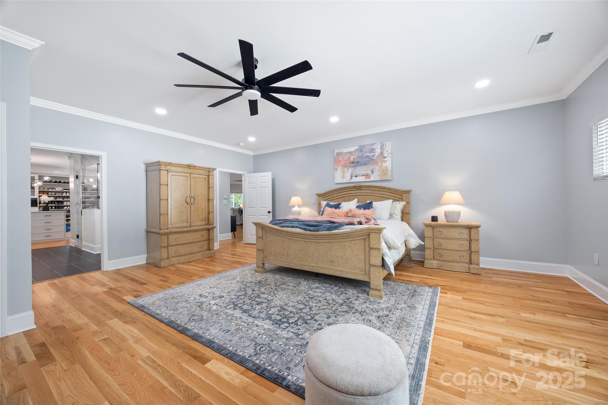 184 Quiet Cove Road Mooresville, NC 28117 - Photo 14 of 45 a bedroom with a bed and a chandelier