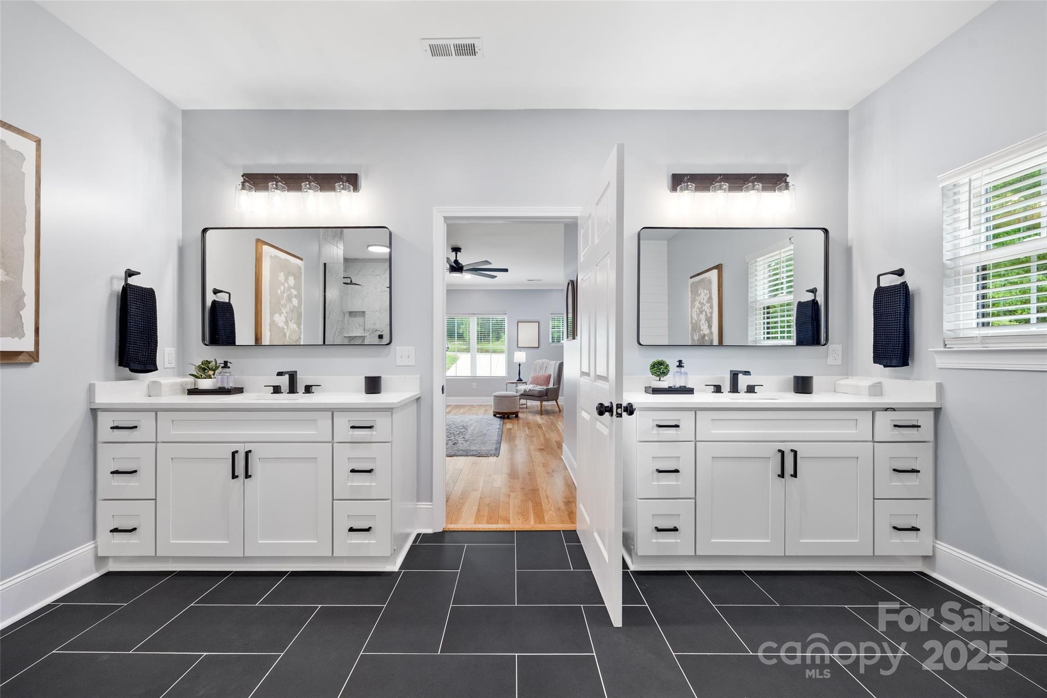 184 Quiet Cove Road Mooresville, NC 28117 - Photo 15 of 45 a spacious bathroom with a double vanity sink mirror and toilet