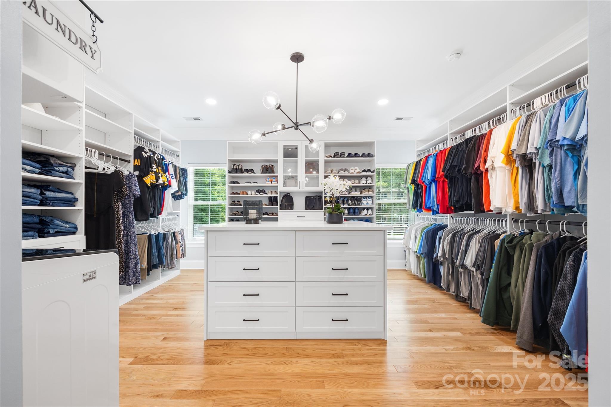 184 Quiet Cove Road Mooresville, NC 28117 - Photo 18 of 45 a view of walk in closet with clothes and shoes