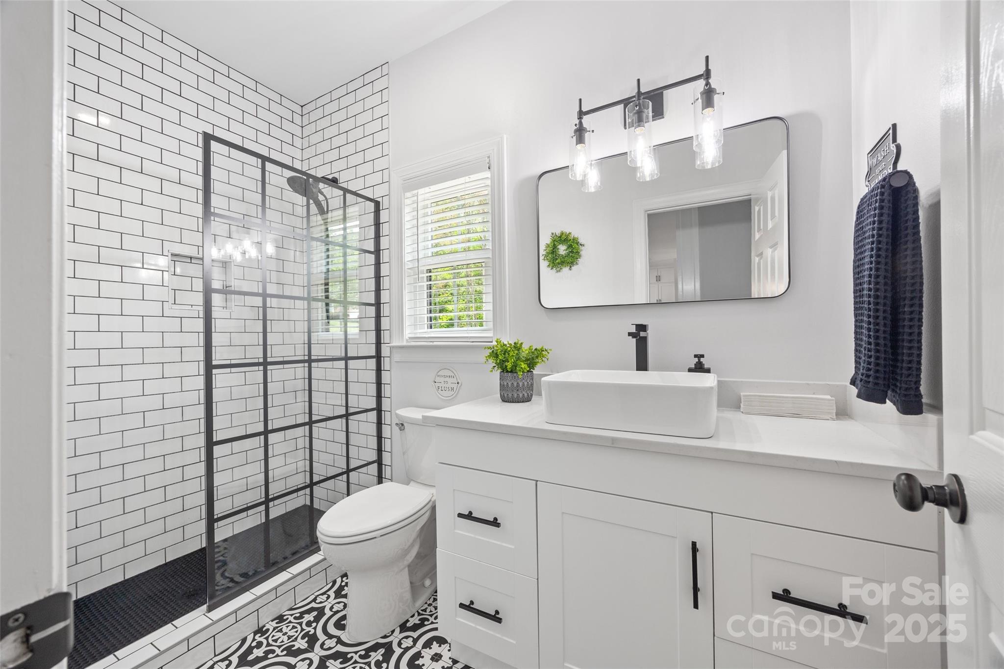 184 Quiet Cove Road Mooresville, NC 28117 - Photo 22 of 45 a bathroom with a sink toilet and shower