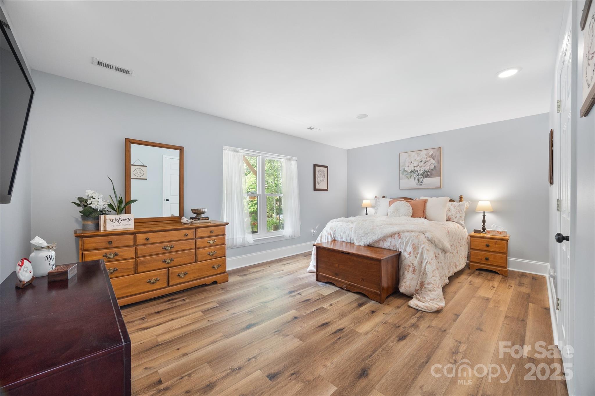 184 Quiet Cove Road Mooresville, NC 28117 - Photo 27 of 45 a bedroom with a bed and wooden floor