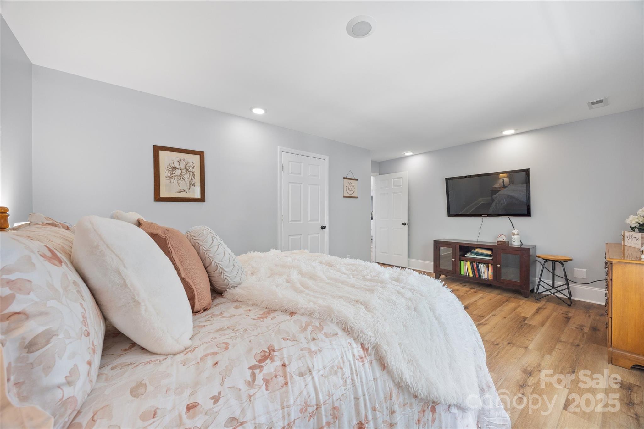 184 Quiet Cove Road Mooresville, NC 28117 - Photo 28 of 45 a spacious bedroom with a bed and a flat screen tv